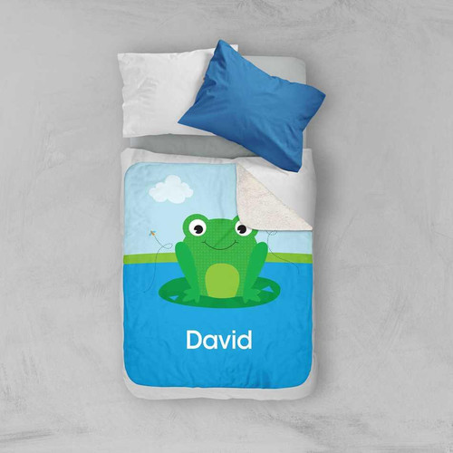 Spark & Spark Cute Smiley Frog Sherpa Blanket, a colorful children's blanket with a smiling frog design and the name David on it, placed on a bed with pillows.