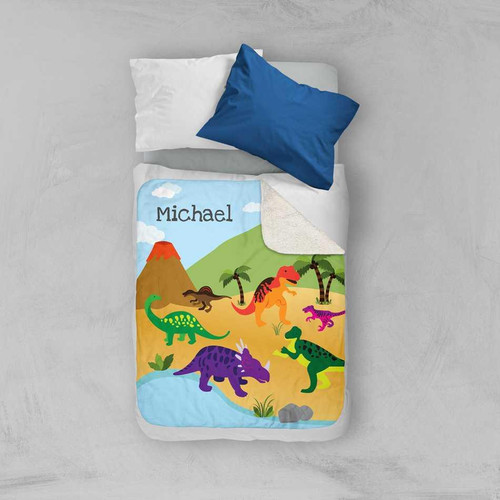 Spark & Spark Dinosaur in the Jungle Sherpa Blanket, colorful dinosaur themed blanket with a jungle landscape and the name Michael embroidered on it.