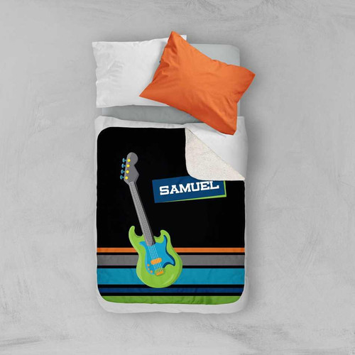 Spark & Spark Guitar sounds Sherpa Blanket, colorful guitar-themed sherpa blanket with black background and vibrant musical design on a bed with white sheets and orange pillow.