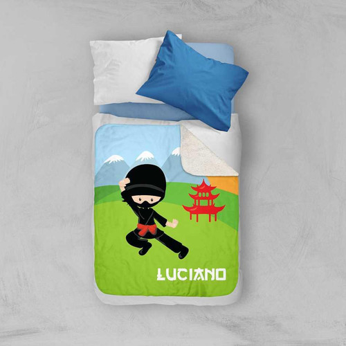 Spark & Spark Cool Super Ninja Sherpa Blanket, colorful blanket with a ninja character, mountains, and pagoda design on a child's bed.