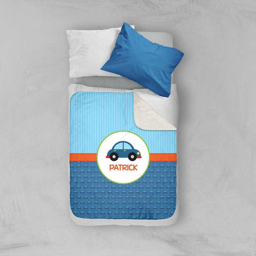 Spark & Spark Cute Little Car Pattern Sherpa Blanket, a blue and white children's blanket with a car theme and personalized with the name Patrick, laid on a bed with pillows.