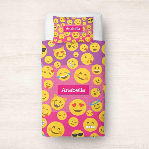Spark & Spark Girl Emojis Duvet Cover featuring a vibrant design with various yellow emoji faces on a pink and purple background, personalized with the name Anabella.