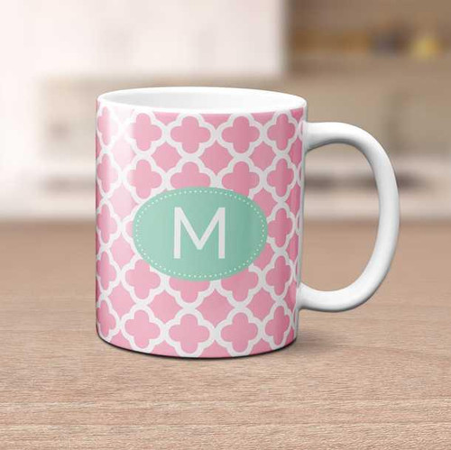 Spark & Spark Quatrefoil Beauty Ceramic Mug, pink and white quatrefoil patterned mug with a monogram letter M on a green oval background.