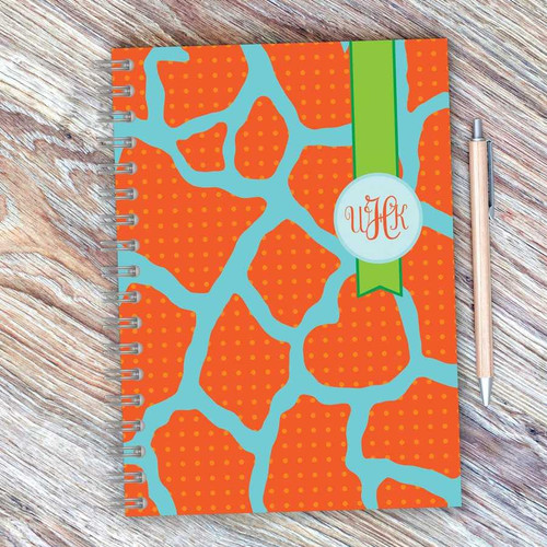 SparkGreetings® Cute Rocks Writing Journal, colorful abstract cover design with orange and blue pattern and a green band with a logo.