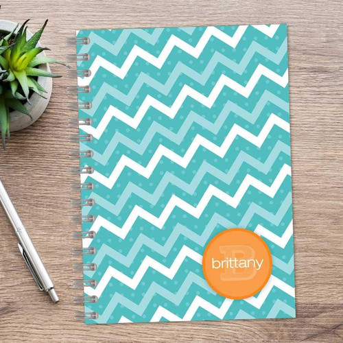 SparkGreetings® Mod Chevrons Writing Journal, teal and white zigzag patterned journal with a personalized orange monogram sticker on the cover.