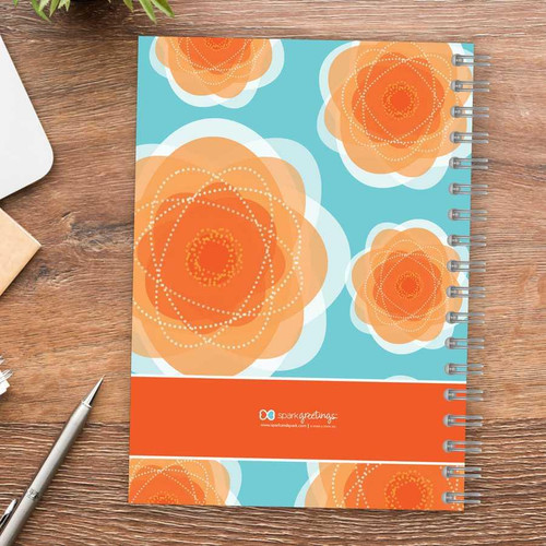 SparkGreetings® Pretty Blooms Writing Journal, featuring a colorful cover design of orange floral patterns on a blue background.
