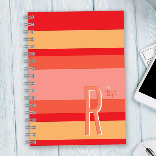 SparkGreetings® Bold and Modern Writing Journal, colorful striped cover with a large letter R and personalized name text.