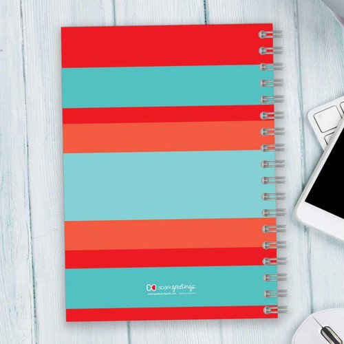 SparkGreetings® Bold and Modern Writing Journal, colorful striped cover in red, orange, and light blue with spiral binding and logo at the bottom.