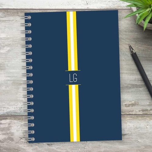 SparkGreetings® Elegant Ribbon Writing Journal, navy blue cover with yellow and white ribbon design and customizable initials 'LG' on the front.