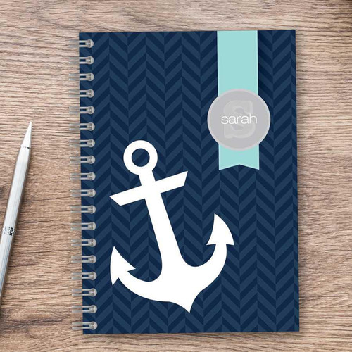SparkGreetings® Small Anchor Writing Journal, navy blue chevron pattern cover with white anchor graphic and customizable name tag reading 'Sarah' on light blue ribbon.