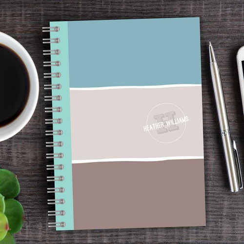 SparkGreetings® Three Stripes Writing Journal, a colorful spiral-bound notebook with three horizontal color blocks in turquoise, white, and taupe, personalized with the name Heather Williams on the cover.