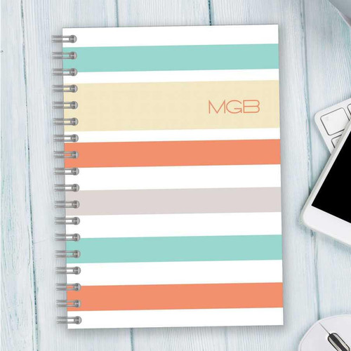 SparkGreetings® Array of Stripes Writing Journal, colorful striped cover design with pastel shades and the initials 'MGB' printed on it.