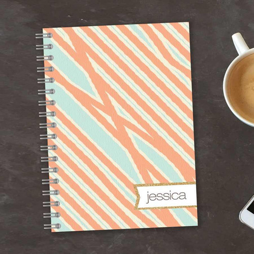 SparkGreetings® Tapestry Pattern Writing Journal, personalized journal with a pastel orange and blue striped pattern and the name Jessica on a label with a gold border.