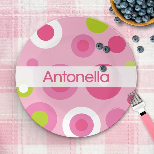 Spark & Spark Circles And Circles Pink Kids Plates with personalized name 'Antonella', colorful circle pattern, on a pink checkered tablecloth with a fork and blueberries.