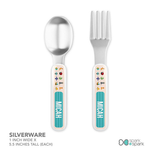 Spark & Spark Animal ABC Beige Kids Placemat, a set of stainless steel spoon and fork with animal-themed handles.