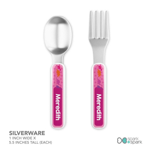Spark & Spark Dinosaur Trails Girl Kids Placemat, children’s silverware set including a spoon and fork with dinosaur trail design on pink handles.