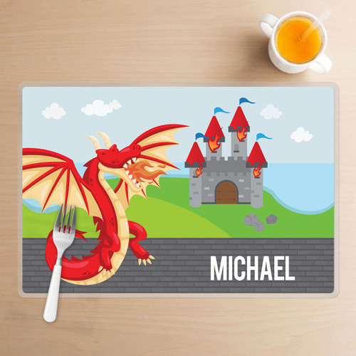 Spark & Spark Dragon Quest Kids Placemat, colorful cartoon dragon with a castle and the name Michael on a dining table.