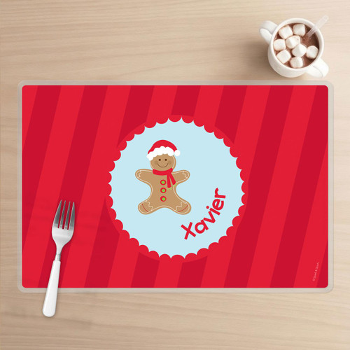 Spark & Spark Xmas Cookie Blue Kids Placemat with gingerbread man wearing a Santa hat and the name Xavier printed on it.
