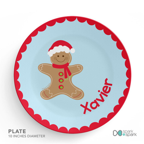 Spark & Spark Xmas Cookie Blue Kids Placemat with a gingerbread cookie character wearing a Santa hat and red scarf, and the name 'Xavier' written in red.