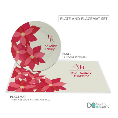 Spark & Spark Shiny Poinsettas Holiday Placemat, a festive holiday table setting with a matching round plate and rectangular placemat featuring red poinsettia flowers and personalized text.
