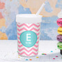 Spark & Spark Chevron Pink and Aqua Toddler Cup, personalized with the name Emily, featuring a pink and white chevron pattern and a matching straw on a white surface with colorful macarons in the background.