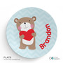 Spark & Spark Love Bear Kids Placemat, round children’s place mat with a cute bear holding a red heart on a light blue zigzag background, personalized with the name 'Brandon' in red text.