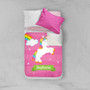 Spark & Spark Playful Pony Sherpa Blanket with personalized name, featuring a colorful unicorn, rainbow, clouds, and stars on a pink background, on a bed with pillows.