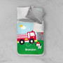 Spark & Spark Fighting Fire Sherpa Blanket, children's fire truck themed Sherpa blanket with personalized name Brandon, illustrated fire truck and Dalmatian dog wearing firefighter hat on green grass background.