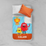 Spark & Spark Monster Attack Sherpa Blanket, colorful kids' blanket with monster characters and the name Caleb, on a bed with pillows.