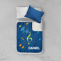 Spark & Spark Musical Notes Sherpa Blanket, personalized with name Daniel, featuring vibrant musical notes on a blue background.