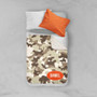 Spark & Spark Brown Camouflage Sherpa Blanket, a cozy camouflage patterned sherpa blanket with a personalized name 'DANIEL' embroidered on it, displayed on a bed with pillows.
