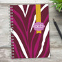 SparkGreetings® Zebralicious Writing Journal, colorful zebra stripe design with yellow ribbon and purple label.