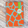 SparkGreetings® Cute Rocks Writing Journal, colorful abstract cover design with orange and blue pattern and a green band with a logo.