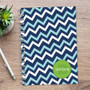 SparkGreetings® Mod Chevrons Writing Journal, spiral-bound notebook with a blue and light blue chevron pattern cover on a wooden surface.