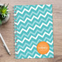 SparkGreetings® Mod Chevrons Writing Journal, teal and white zigzag patterned journal with a personalized orange monogram sticker on the cover.