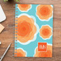 SparkGreetings® Pretty Blooms Writing Journal with orange floral design on a blue background, featuring a red and white BMN logo in the bottom right corner.