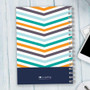 SparkGreetings® Beautiful Colors Writing Journal, vibrant chevron pattern in orange, teal, navy, and light blue on a spiral-bound notebook.