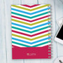 SparkGreetings® Beautiful Colors Writing Journal, colorful chevron pattern design on cover with spiral binding and logo at the bottom.