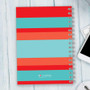 SparkGreetings® Bold and Modern Writing Journal, colorful striped cover in red, orange, and light blue with spiral binding and logo at the bottom.