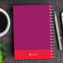 SparkGreetings® Urban Graffiti Writing Journal, purple spiral-bound notebook with graffiti design on cover placed on wooden table alongside pen, coffee cup, and green plant.