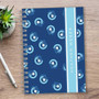 SparkGreetings® Small Swirls Writing Journal, blue cover with small swirl pattern and a white stripe with the name 'Heather Webber' on it.