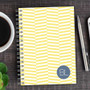 SparkGreetings® Up and Down Style Writing Journal, yellow and white striped patterned cover with a blue 'BL' monogram on the bottom right corner.