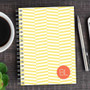 SparkGreetings® Up and Down Style Writing Journal, yellow and white chevron patterned spiral-bound notebook with an orange circle containing 'BL' on the cover.