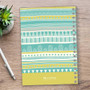 SparkGreetings® Tribal Mood Writing Journal, colorful tribal pattern cover with geometric designs in shades of teal, yellow, and white.