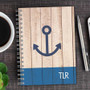 SparkGreetings® Rustic Anchor Writing Journal, wooden cover design with a navy blue anchor graphic and 'TLR' text on the bottom right corner.