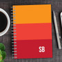 SparkGreetings® Shades of Color Writing Journal, color-blocked cover with red, orange, and yellow shades and 'SB' initials at the bottom right corner.