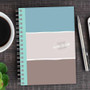 SparkGreetings® Three Stripes Writing Journal, a colorful spiral-bound notebook with three horizontal color blocks in turquoise, white, and taupe, personalized with the name Heather Williams on the cover.
