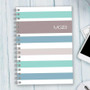 SparkGreetings® Array of Stripes Writing Journal, a spiral-bound notebook with pastel-colored horizontal stripes on the cover.