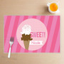 Spark & Spark Sweet & Yummy Pink Kids Placemat, pink striped placemat featuring an ice cream cone graphic with sprinkles, customizable with the name Nicole.