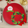 Spark & Spark La Tradicion de la Corona Holiday Placemat, festive red holiday placemat with a holly branch design and a green banner for Christmas decor.